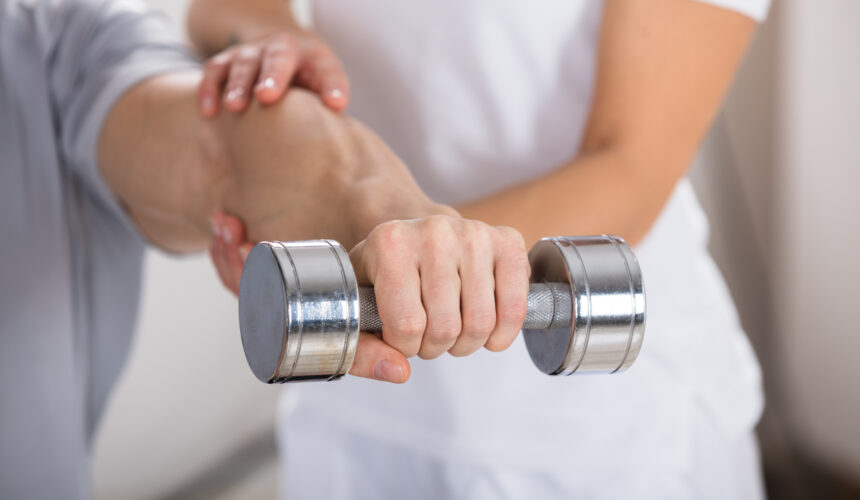 man holding dumbell physiotherapy