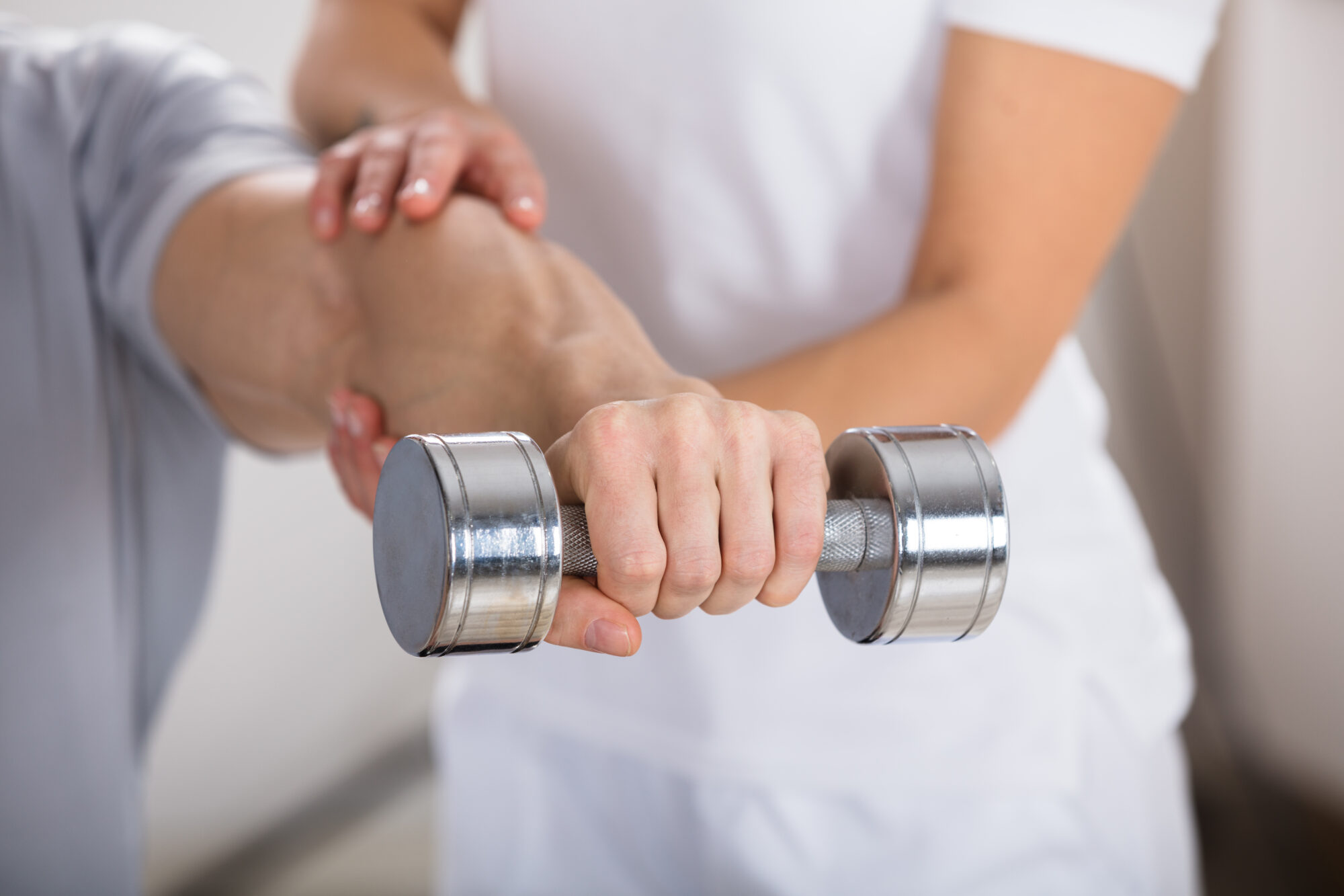 man holding dumbell physiotherapy