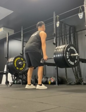 Athlete doing deadlifts posterior view to check for form