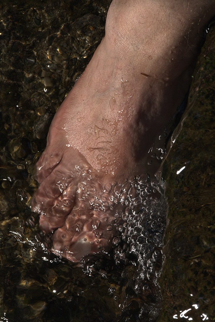 foot going into ice bath water