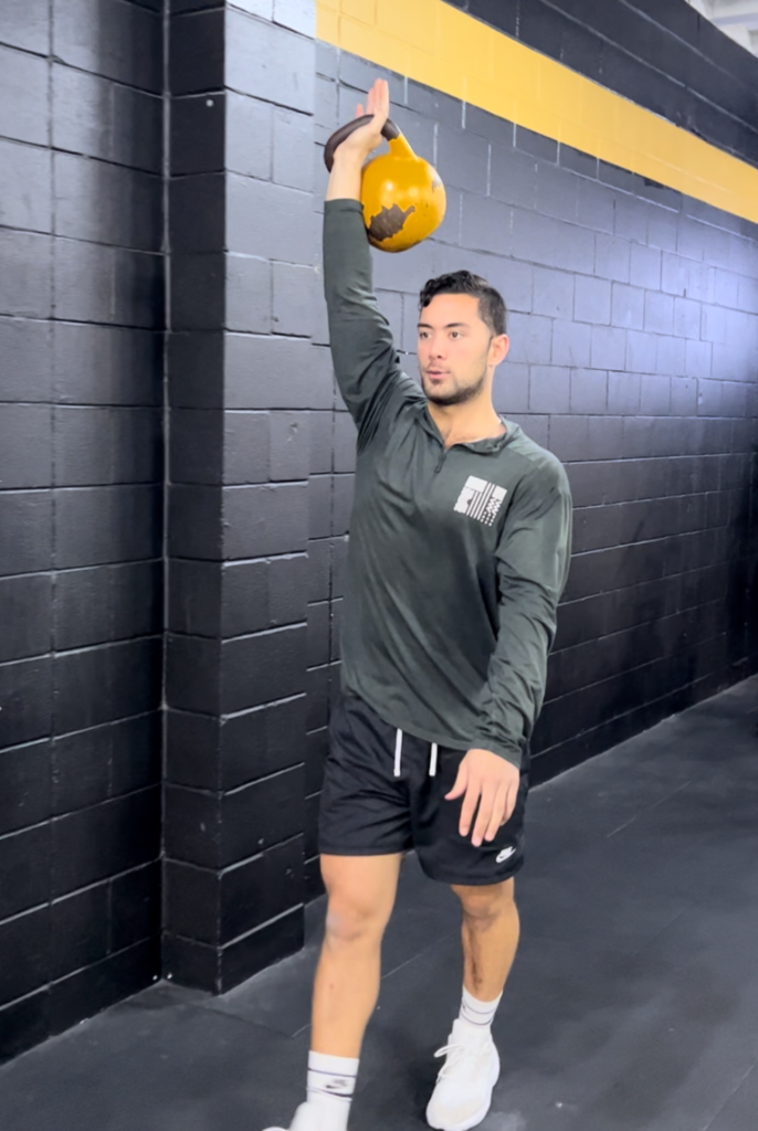 Physio holding a kettlebell