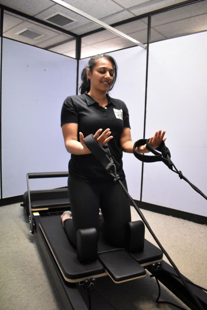 Physio showing reformer pilates
